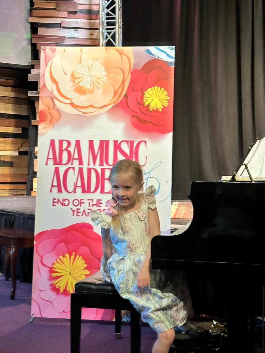A young beginner on stage at ABA Music Academy's 2026 end-of-year concert