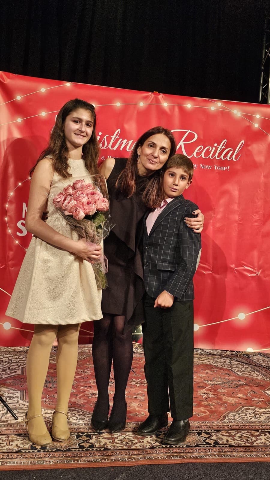 Two students celebrating with their teacher after the recital finale