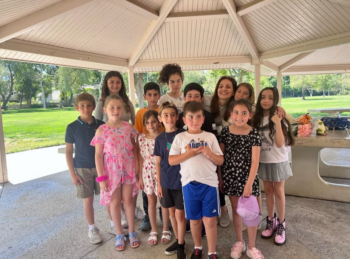 ABA Music Academy students and teachers gathered at a park gazebo in summer